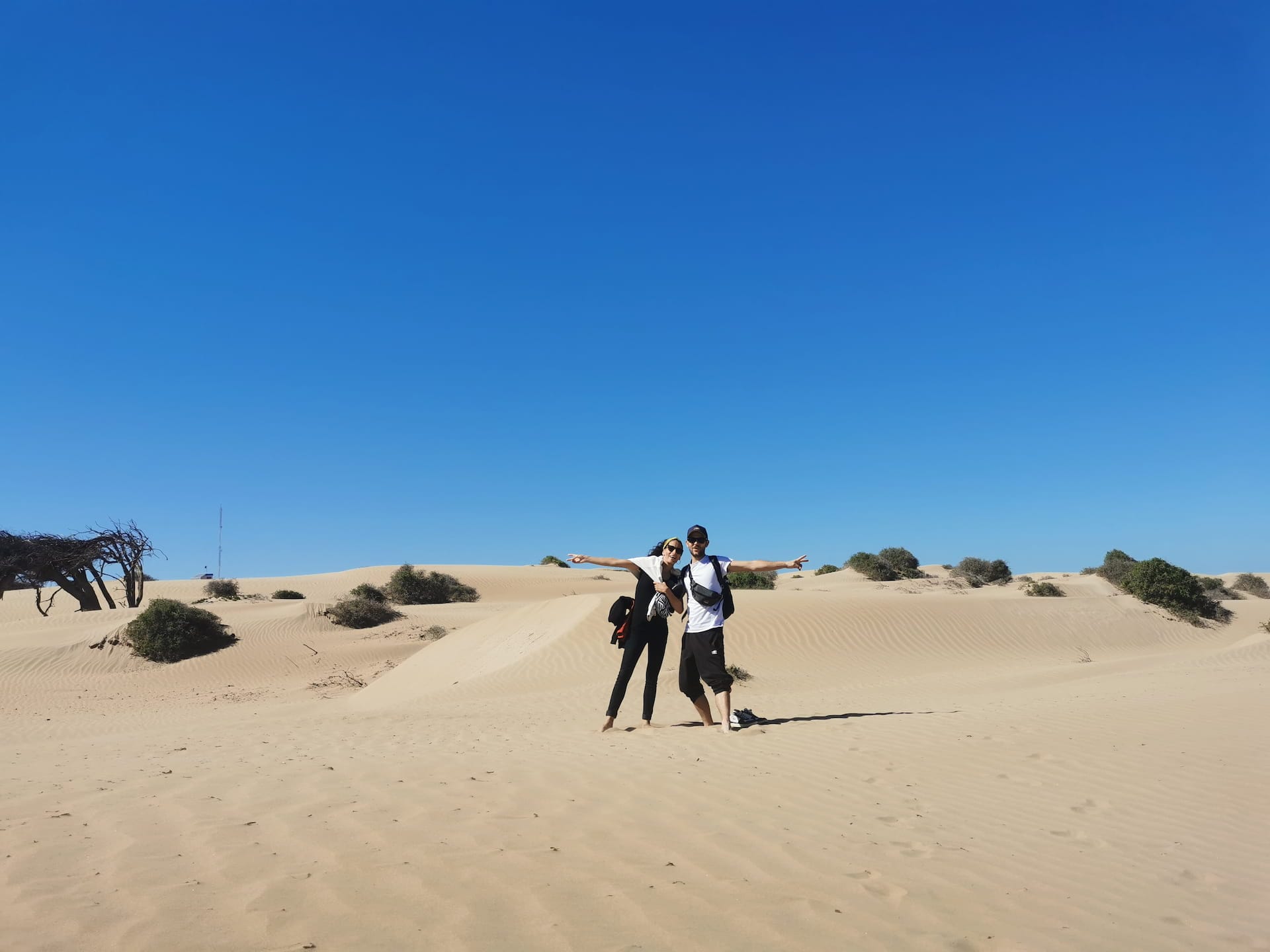 two tourists enjoying holidays in the desert of morocco